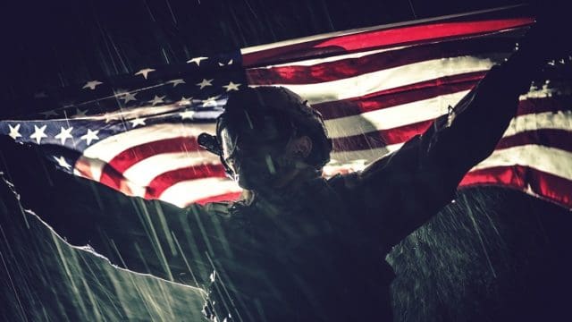 Proud American Army Soldier with National Flag in Hands During Heavy Thunderstorm and Rainfall. United States of America. Victory Concept. Military Theme.