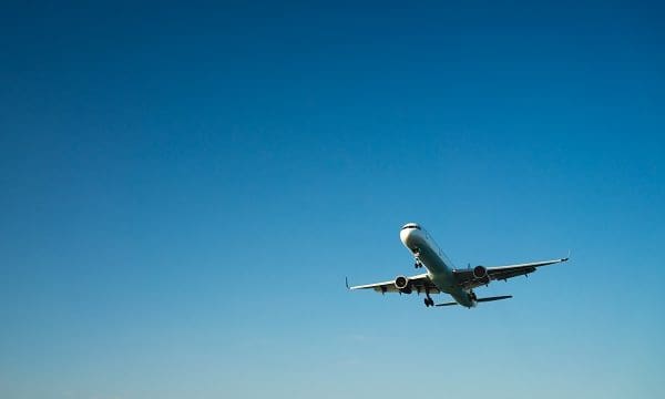 modern airplane travel, clear blue sky in background