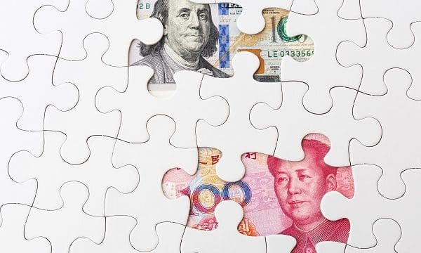 White puzzle with US and chinese banknote