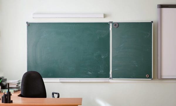 School classroom background without young student. view of class room no kids. blackboards and empty place of teacher