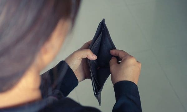 woman open wallet with no money inside