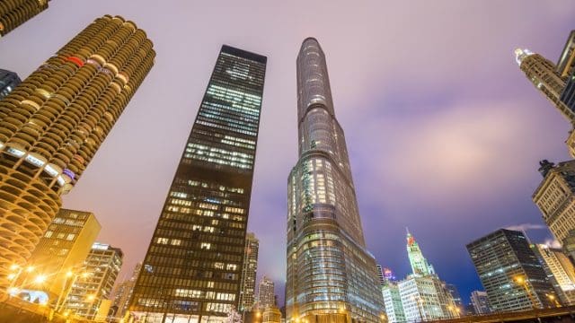View of skyscrapers in Chicago at night as seen from the banks of the Chicago River