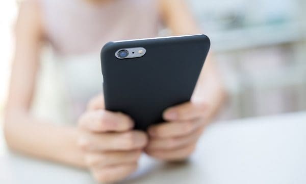 Woman sending sms on cell phone