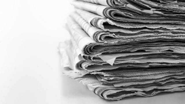 Newspapers folded and stacked concept for global communications and the media