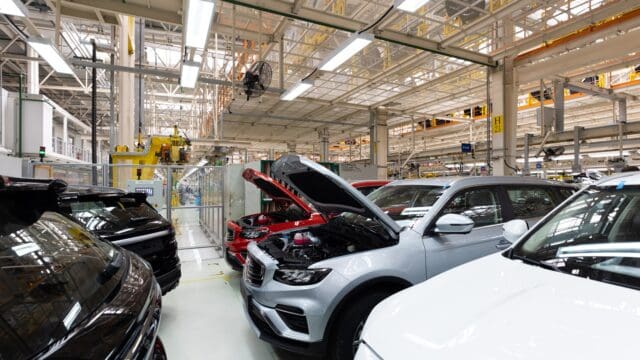Modern car assembly plant. Auto industry. Interior of a high-tech factory, modern production of automobiles.