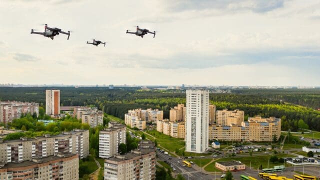 Drones flying over the houses of the city of Minsk. Urban landscape with drones flying over it.Quadrocopters fly over the city