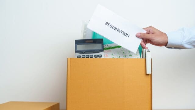 Resignation, Layoff, Unemployment, Dismiss, Job quit, Jobless and Farewell concept. Businessman holding letter of Resign contract with documents cardboard box at office