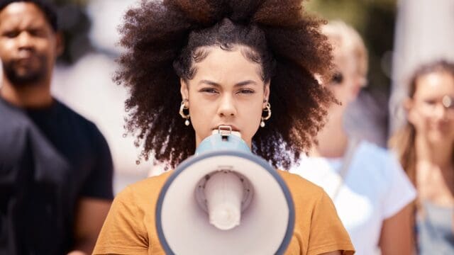 Freedom, revolution and megaphone with woman in protest event for community, support and leadership.