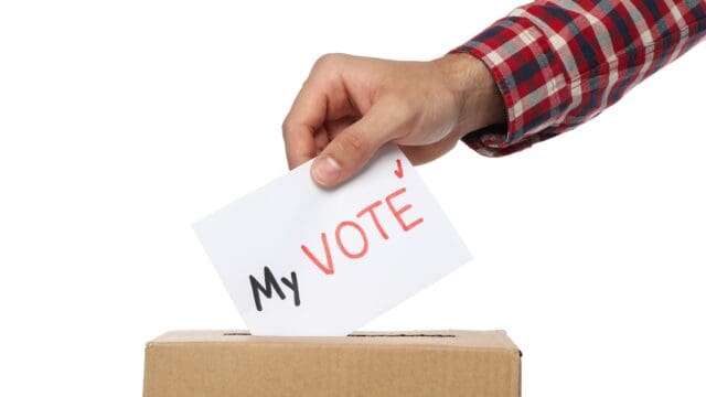 Man putting ballot into voting box, isolated on white background