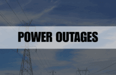 Rectangle containing the text Power Outages with power transformers in the background