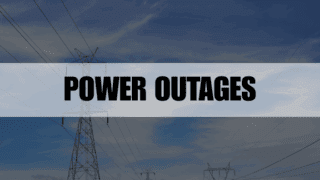 Rectangle containing the text Power Outages with power transformers in the background