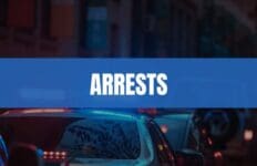 Text that says Arrests on a light blue rectangle with police cars in the background