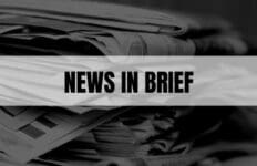 Text that says News In Brief on a white rectangle with newspapers in the background