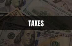 Text that says Taxes on a black rectangle with an image of money in the background